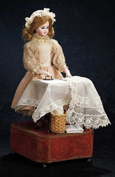 a doll sitting on top of a suitcase