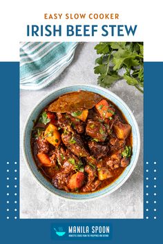 the easy slow cooker irish beef stew in a blue bowl with parsley on top