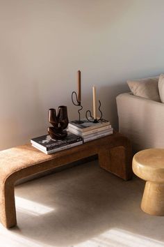 a coffee table with two candles on it