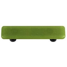 a green skateboard sitting on top of a white surface