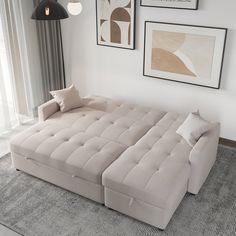 a living room filled with furniture and pictures hanging on the wall over a gray rug