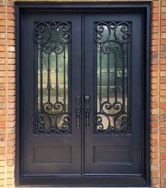 a black double door with wrought iron designs