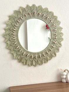 a mirror hanging on the wall above a dresser