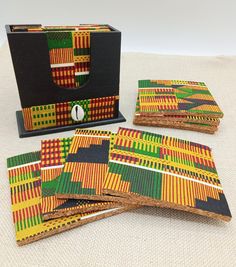 The African Kente coasters comes in set of 4. Great gift ideas for any room. These are coated but should not be washed in dishwasher.  If you need a large order please contact us. If you have any questions please feel free to contact us at anytime. Please check out sale on blackertheberry.net for more. Our products are not intended for babies or children as we use small pieces, wires and beads. These can be dangerous to them when unsupervised. Gift boxes and gift messages are available for your special orders. If you need the sizes in cm ,mm or in other sizes we will provide that information. Contact us at blackertheberry@ sbcglobal.net for any questions. Please feel free to leave a review and thank you for supporting our small business The Blacker The Berry®. Check us out at TheBlackerThe Afrocentric Decor, African Gifts, African Home Decor, Loc Jewelry, African Decor, African Inspired, Wood Jewellery, Handmade Home Decor, Handmade Home