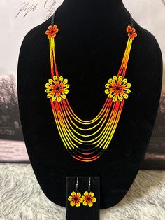 Beautiful set of necklace and earrings handmade by Mexican artisans. Dangling Beads Jewelry Set As A Gift, Dangle Jewelry Sets With Dangling Beads As Gift, Dangling Bead Jewelry Sets As Gifts, Handmade Orange Multi-strand Necklace, Handmade Long Yellow Necklace, Handmade Orange Long Necklace, Handmade Orange Necklace, Orange Beaded Chain Jewelry For Gift, Unique Yellow Jewelry With Matching Earrings