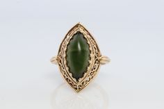 Wonderful Dark Green Jade Cabochon ring. Jade is dark green color. Bezel set.  3.4grams total weight 15mm by 7mm marquise cabochon Hallmarked and tested 14k sz7 Stock111 Formal Green Cabochon Rings, Elegant Green Cabochon Emerald Ring, Elegant Green Emerald Cabochon Ring, Heirloom Jade Jewelry In Green, Heirloom Green Jade Jewelry, Antique Green Emerald Ring With Polished Finish, Green Cabochon Rings In Art Deco Style, Antique Green Jewelry With Polished Finish, Green Cabochon Art Deco Rings