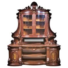 an ornate wooden desk with glass doors and shelves on it's sides, in front of a white background