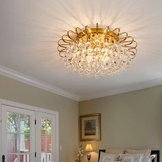 a bed room with a neatly made bed and a chandelier hanging from the ceiling