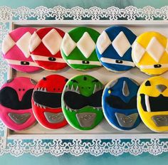 decorated cookies in the shape of different types of helmets are displayed on a white tray