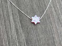 This beautiful Star of David /Magen David/Jewish Star Opal Necklace is sure to be someone's favorite. It's a great Bat Mitzvah or Hanukkah gift. Sterling Silver or 14kt Gold Filled Charm Size: 10mm Lab Created Opal Your Choice of Length and Color Chain Styles: 0.7mm Box Chain Disclaimer: Before placing an order for a necklace or bracelet, please ensure you measure your desired size carefully. Customers are fully responsible for choosing the correct length, as all cut chains are non-refundable. I Star Of David Charm Jewelry Gift, Hanukkah Gift Pendant Jewelry, White Star Of David Jewelry Gift, Star Of David Necklace For Gift, Sterling Silver Jewelry For Hanukkah Gifts, Star Of David Necklace For Hanukkah Gift, Hanukkah Gift Necklace With Star Of David, Spiritual Jewelry For Hanukkah Gift, Judaica Jewelry