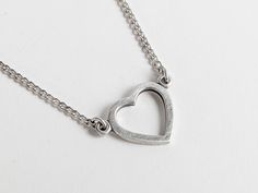 Infuse a dash of 90s charm into your accessory collection with this vintage heart pendant necklace. Beautifully crafted from silver (stamped on the back), this lovely piece features an openwork filigree heart outline hanging gracefully from a curb chain and fastens with a non-original, over-sized silver tone spring ring. Its minimalist design is ideal for adding a subtle statement to any outfit. This delightful necklace would serve as a heartfelt token of affection, making it a splendid love gif Everyday Metal Heart Pendant Charm Necklace, Everyday Metal Charm Necklace With Heart Pendant, Minimalist Heart-shaped Metal Charm Necklace, Minimalist Metal Heart Necklace For Everyday, Everyday Metal Open Heart Necklace, Everyday Open Heart Metal Necklace, Everyday Adjustable Heart Pendant Charm Necklace, Metal Open Heart Charm Necklace, Everyday Metal Heart Necklace For Valentine's Day