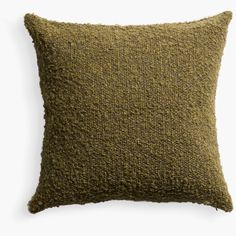 a green pillow with a textured design on the front and back, sitting on a white background