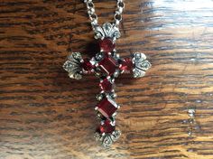 A stunning antique sterling silver cross pendant set with faceted garnets and decorated with marcasites on a long sterling silver belcher chain. The seven prong set dark red faceted garnets are square and round cut. The pendant is marked 925 for sterling silver and has a Birmingham maker's mark. It probably dates from the early 1900s. The 55 cm belcher chain is 2.5 mm wide with a spring ring fastening. This item is in good condition with one damaged marcasite shown in the last photo. Thank you f Antique Silver Garnet Jewelry, Antique Silver Cross Necklace Gift, Antique Silver Cross Necklace As Gift, Antique Silver Cross Necklace For Gift, Vintage Red Cross Jewelry, Gothic Silver Garnet Jewelry, Belcher Chain, Sterling Silver Cross Pendant, Sterling Silver Marcasite