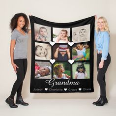 two women standing next to each other holding up a black blanket with pictures of them