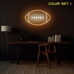 a desk with a laptop and a neon football sign above it that reads, color set 1