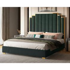 a bedroom with a large bed and green headboard