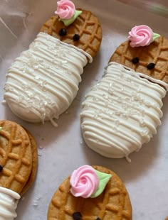 some cookies are decorated with icing and flowers