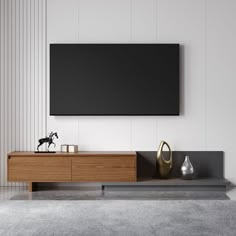 a modern living room with a large flat screen tv mounted on the wall above it