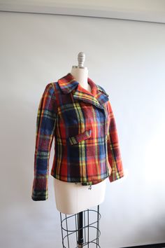 An amazing cropped plaid motorcycle jacket. Picked this up in Germany. Beautiful bright colors.  90% wool.  Fits like a small.  20.5" long 18" bust 17" waist 22" sleeve length 14.5" shoulder seam to shoulder seam In okay vintage condition. Some thinning to the wool, especially at the cuffs. Some pilling, see photos. There is wear and minor staining to the lining and the hanging loop is undone. Fall Plaid Patchwork Outerwear, Vintage Plaid Long Sleeve Outerwear, Vintage Plaid Collared Outerwear, Vintage Plaid Outerwear With Button Closure, Plaid Patchwork Button-up Outerwear, Blue Check, Wool Plaid, Yellow Blue, Orange Red