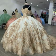 a dress on display in a store with other gowns and mannequins behind it