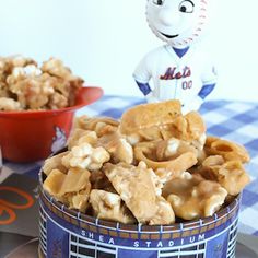 a baseball player figurine sitting on top of a bowl filled with cereals