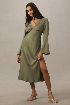 Drawing inspiration from the 1970s, an ascending point bodice and long bell sleeves adorn this streamlined satin midi. | Avani V-Neck Long-Sleeve Satin Midi Dress by BHLDN in Green, Women's, Size: Smallmall, Viscose/Elastane/Satin at Anthropologie Green Bell Sleeve Dress, Wedding Guest Dress With Sleeves, Long Sleeve Wedding Guest Dress, Free Spirit Chic, Scandinavian Dress, Spring Wedding Guest Dress, Elegant Evening Gowns, Wedding Outfit Ideas, Fresh Beauty