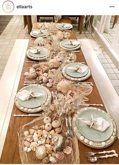 a long table with plates and silverware on it, along with other place settings