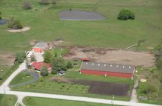 an aerial view of a farm and barn