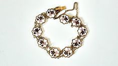 "Vintage Japanese cloisonne bracelet, floral enamel link bracelet. Please zoom in for details, photos are part of description. This enamel bracelet has a white background with red and pink flowers. The back has a gold metal finish, and it has a safety chain. The bracelet measures 7 1/2\" end to end and in very good vintage condition, no damage to enamel. Please review store policies prior to purchasing  Thanks for your interest" White Flower Bracelets For Formal Occasions, Formal White Flower-shaped Bracelets, Formal White Flower Bracelet, Formal White Flower-shaped Bracelet, White Enamel Bangle Jewelry, White Enamel Bracelet Jewelry, Antique White Bracelet Jewelry, White Antique Bracelet Jewelry, White Antique Bracelet