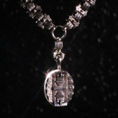 True to the opulence of its era—circa 1890 in Birmingham, England—this antique silver buckle locket necklace is like none other. The Sterling silver locket, which can hold two images inside, can be removed from the ornate double-layer silver chain. This one of a kind Victorian locket is engraved with a double buckle and floral motif, as well as its hallmark stamps indicating its origin and maker’s mark. Metal: Sterling SilverMeasurements: Locket length: 2.5", Locket width: 1.5", Chain length: 18", Chain width: .25-.75", Overall length: 24"Weight: 80g Antique Silver Oval Pendant Locket Necklace, Antique Silver Oval Pendant Necklace With Locket, Antique Silver Locket Necklace With Oval Pendant, Antique Silver Necklace With Oval Locket Pendant, Elegant Silver Jewelry With Vintage Charm, Elegant Vintage Charm Oval Link Jewelry, Elegant Jewelry With Vintage Charm And Oval Link, Victorian Style Medallion Coin Pendant Jewelry, Antique Silver Locket Necklace For Formal Occasions