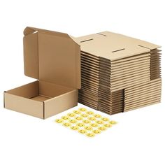 a cardboard box filled with lots of yellow smiley face stickers next to it's contents