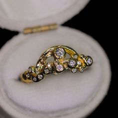 This sparkly ring design is our new Rainbow & Cloud ring (but the largest diamond represents the "sun") in 14K gold and encrusted with diamonds. This piece is imbued with sunshine and joy. A rainbow and sparkling diamonds are set into bubbly "clouds", an abstract representation of sunshine and joy after the rain. Nicole created this ring with different methods of ancient goldsmithing and fusing and then created a mold so that we can recreate this in different 14K gold colors. It is truly a spiri 14k Gold Anniversary Diamond Ring With Rose Cut, Heirloom Style Crystal Diamond Ring, Celestial Single Cut Diamond Promise Rings, Gold Platinum Jewelry With Single Cut Diamonds, Heirloom Diamond Crystal Promise Ring, White Gold 14k Rose Cut Diamond Ring, Celestial Diamond Ring With Accents For Promise, Celestial Style Promise Diamond Ring With Accents, Crystal Promise Ring With Rose Cut Diamonds