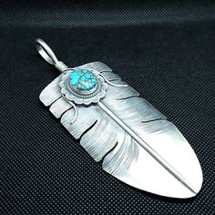 Turquoise Feather Sterling silver Pendant necklace Length: 5 inches Width: 2 inches Handmade in USA Blue Nile Jewelry, Silver Hair Pin, Bolo Ties, Turquoise Bead Bracelet, Silver Choker, Silver Feather, Bolo Tie, Sterling Silver Cuff Bracelet, Sterling Silver Dangle Earrings