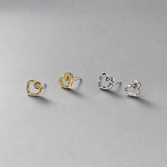 Introducing the Sparkly Heart Stud Earrings - a charming and dainty accessory crafted from 925 sterling silver, with an 18k gold-plated option available. These heart-shaped earrings, measuring 0.8cm x 0.9cm, are adorned with six sparkling cubic zirconia stones, adding a touch of elegance and shine to any look. Perfect for everyday wear or special occasions, the Sparkly Heart Stud Earrings are a beautiful expression of love and a delightful addition to any jewelry collection. Elegant Sterling Silver Heart-shaped Earrings, Elegant Sterling Silver Open Heart Earrings, Elegant Silver Earrings With Heart Charm, Silver Plated Earrings For Gift, Silver Plated Earrings As Gift, Elegant Silver Heart Earrings For Mother's Day, Silver Tarnish Resistant Heart Earrings For Anniversary, Silver Plated Sterling Silver Earrings, Elegant Silver Heart Charm Earrings