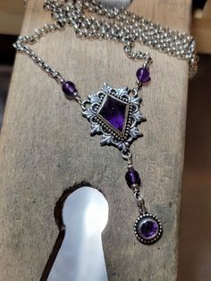 This is a handmade, one of a kind amethyst and sterling silver necklace. In addition to being the birthstone of February, many cultures find spiritual overtones in amethysts. Often viewed as a stone of peace, some believe amethyst's calming presence produces soothing dreams by bringing the dreamer more in tune with the Divine. Amethysts are said to have calming, soothing energy. The centerpiece of the necklace measures about 1 inch long by just over .75 inch wide. The dangling faceted amethyst i Handmade Silver Dainty Drop Necklace, Adjustable Sterling Silver Drop Necklace, Sterling Silver Dangle Necklace, Sterling Silver Adjustable Drop Necklace Gift, Adjustable Sterling Silver Pendant Necklace, Sterling Silver Adjustable Drop Necklace For Gifts, Adjustable Sterling Silver Drop Necklace For Gift, Purple Gemstone Metal Jewelry, Nickel Free Adjustable Necklace For Formal Occasions