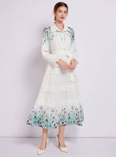 Captivating and ethereal, this enchanting long-sleeved dress is a portrait of bucolic elegance. Its fitted bodice descends into a gently tiered skirt, creating a silhouette that’s both classic and whimsical. The crisp white fabric serves as a canvas for delicate floral patterns that bloom across the hem, lending a touch of springtime regardless of the season. Lace trims add a sophisticated touch, framing the neckline and cuffs with exquisite detail. With a cinched waist accentuated by a self-tie belt, this dress shapes a figure that is both graceful and poised. It’s a versatile piece that transitions seamlessly from a countryside stroll to a chic urban evening. Fabric name: polyester fiberPattern: printingSkirt length: long skirtSkirt type: large swing typeSleeve length: long sleevesColor: Lapel Dress, Soft Lavender, Antique Fashion, Lace Trims, Sleeved Dress, Dress Shapes, Charm Set, Tiered Skirt, Cinched Waist