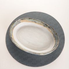 an empty plate on a white table with black trimmings and silver rimmed edges