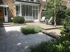 an outdoor patio with steps leading to the front door