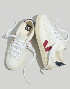 Founded in Paris, Veja makes eco-friendly sneakers that don't look eco-friendly (aka, they're feel-good shoes without the crunch factor). These versatile low-tops are made in Brazil from sustainable materials, including organic cotton and recycled polyester, plus soles made from a blend of recycled rubber, rice waste and natural wild rubber.Not sure what your European shoe size is? Our size chart will help you out.Leather upper.Imported.Madewell.com only. Parisian Capsule Wardrobe, Paris Winter Fashion, What To Wear In Paris, Veja Shoes, European Shoes, Long Black Coat, Mesh Sneakers, Fall Capsule Wardrobe, Summer Lookbook