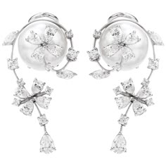 Presented by the acclaimed Designer Stefan Hefner, we are delighted to offer these exquisite and delicate Estate Earrings showcasing lustrous pearls adorned with brilliant diamonds. A floral motif, with movable flower accents - crafted in 18K White Gold and Italian made. Anchoring the earrings are a pair of 12mm High Luster South Sea Pearls of a beautiful soft silvertone and fine quality.  Surrounding each Pearl, (14) round Brilliant-Cut Diamonds, (18) Pear-Cut Diamonds & (4) Marquise-Cut Diamon Luxury Flower Shaped Engagement Earrings, Luxury Gold Flower Earrings Fine Jewelry, Luxury Fine Jewelry Clip-on Earrings, Luxury Flower Earrings With Diamond Accents For Wedding, Luxury Fine Jewelry Flower Earrings As Gift, Luxury Ornate White Earrings, Unique Luxury White Jewelry, Luxury Gold Flower Earrings In Fine Jewelry Style, Luxury Clip-on Fine Jewelry Earrings