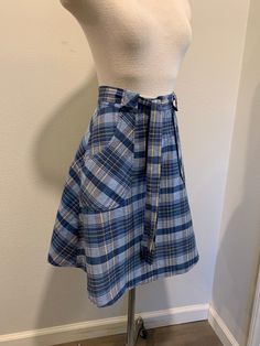 1970's Vintage Wrap Around Skirt ~ Navy Blue Vintage Plaid Print Skirt, Very Good Condition The two last photo shows its small issues. I will be mailing it Priority Mail and First Class International. Measurements Adjustable Waist ~ 26 Inch Length ~ 22 Inch High Waist Retro Pleated Skirt, Relaxed Vintage Skirt With Pockets, Retro Cotton Pleated Skort, Retro Pleated Cotton Skort, Blue Retro Cotton Skort, Retro Blue Cotton Skort, Retro Cotton Bottoms For School, Retro Blue Cotton Skirt, Retro Cotton School Bottoms