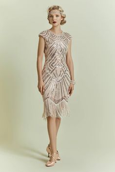 This elegant dress is classic vintage look for a modern woman. The eyecatching design features art deco print and unique vintage style which bring you back to the roaring twenties. Features: Crew neck Back?zipper closure Below the knee Glittering beads Gatsby Style Beaded Fringe Cocktail Dress, Fitted Art Deco Flapper Dress Embellished, Fitted Embellished Flapper Dress In Art Deco Style, Fitted Art Deco Embellished Flapper Dress, Sleeveless Art Deco Embellished Dress, Art Deco Embellished Sleeveless Dress, Gatsby Style Fitted Sequin Dress For Party Season, Art Deco Sequin Summer Dresses, Gatsby Style Fitted Sequin Cocktail Dress