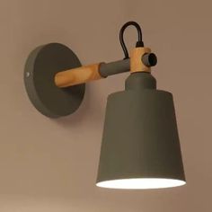 a gray wall light with a wooden arm