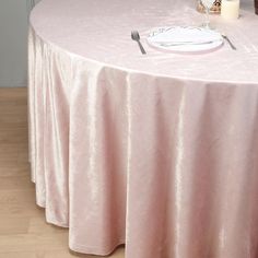 a round table with a white plate and silverware on it