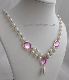 This exquisite Renaissance-style necklace is a timeless classic. Featuring 14x 10mm acrylic gems and 6mm creamy white glass pearls, this dainty piece will add a hint of luxury to any Renaissance and Victorian look. The Irina necklace will add a subtle touch of elegance to any garb ensemble. Necklace length is 17-18", with a 2-3" extender attached. Longer and shorter lengths available upon request, message me with your desired length. Classic Amethyst Necklaces For Wedding, Elegant Amethyst Jeweled Necklaces, Formal White Amethyst Jewelry, Elegant Amethyst Jewel Necklace, White Amethyst Jewelry For Formal Occasions, Elegant Faceted Pearl Necklace, Elegant Pearl White Necklace With Faceted Beads, Elegant Amethyst Necklace, Elegant Gold Pearl Necklace With Faceted Beads