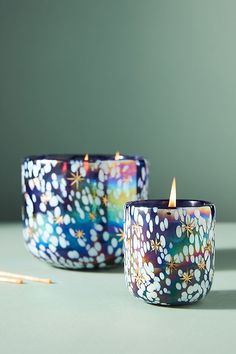 two candles sitting next to each other on a table