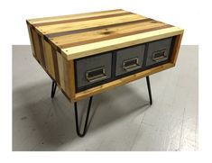 a wooden table with three drawers on it