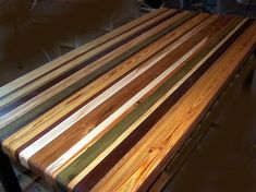 a large wooden table sitting on top of a hard wood floor next to a wall