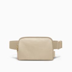 a beige belt bag on a white background