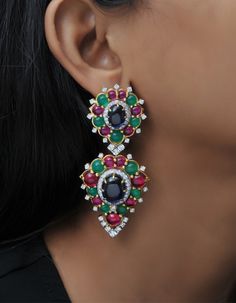 All of the products are MADE TO ORDER in India. They are handcrafted by me and my expert artisan team. This mix color dangle earrings feature a blue cabochon surrounded by the tiny round CZ and the second halo of red & green cabochon. A must for that special night on the town. *Gemstone Grade: AAAAA (Natural Diamond Coated) *Base Metal: 925 Sterling Silver *Plating: Rhodium Plated          *       Product Code: SKU: AAER_DE_267 *PLEASE NOTE* *   This product is completely eco-friendly and non-ag Luxury Jeweled Earrings For Festive Occasions, Luxury Jeweled Silver Earrings, Multicolor 17 Jewel Earrings For Party, Multicolor Diamond Gemstone Earrings, Traditional Drop Earrings With Gemstone Accents, Diamond Earrings With Gemstone Accents For Party, Traditional Gemstone Drop Earrings, Elegant Multicolor Diamond Earrings, Diamond Multi-stone Drop Earrings